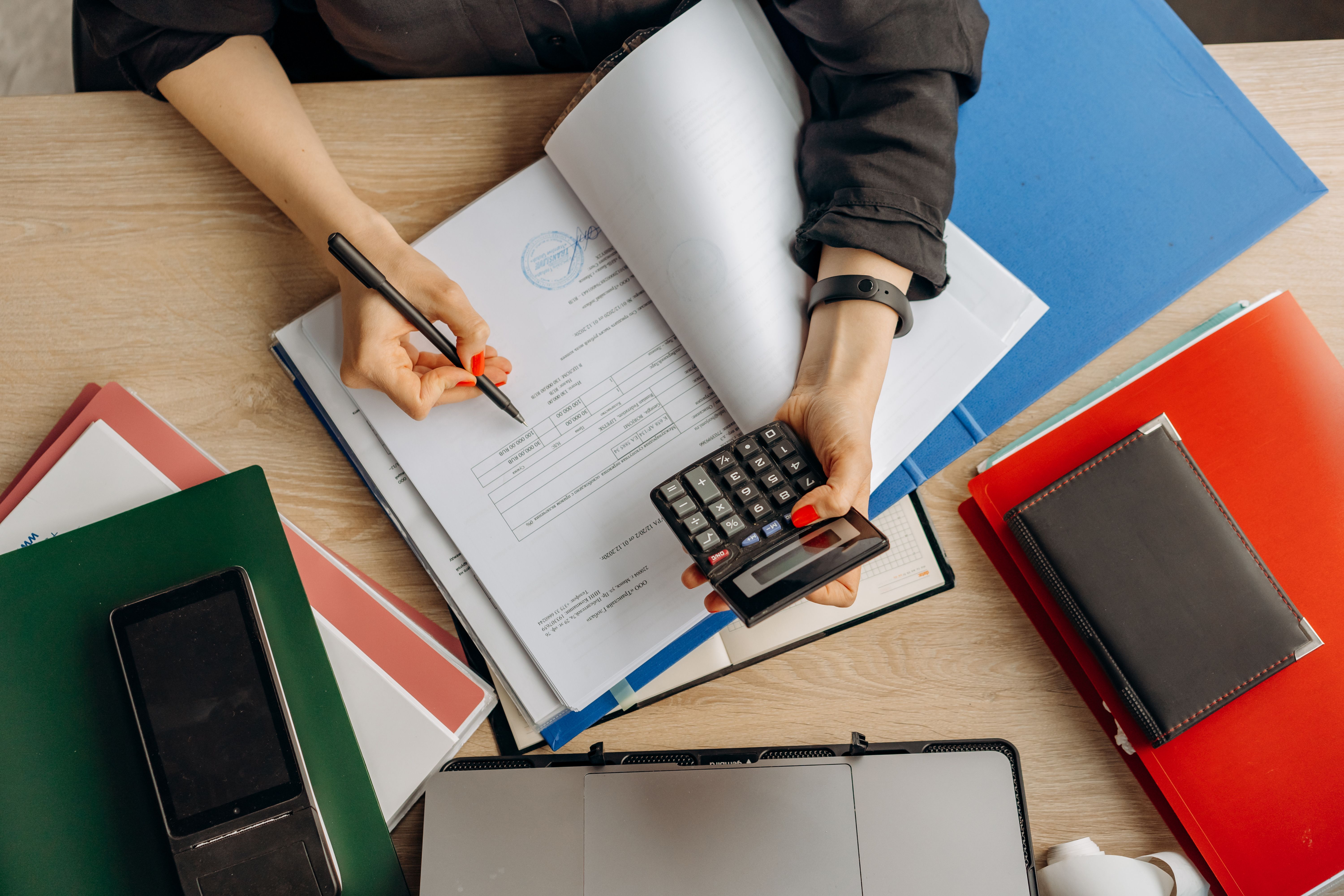 An accountant working on invoices at a desk