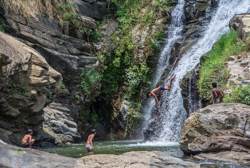 Boys jumping into waterfall in Sri Lanka