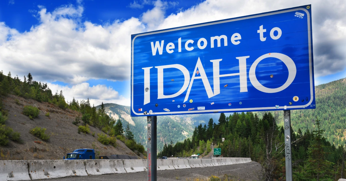 Traffic drives past the Welcome to Idaho sign on Interstate 90