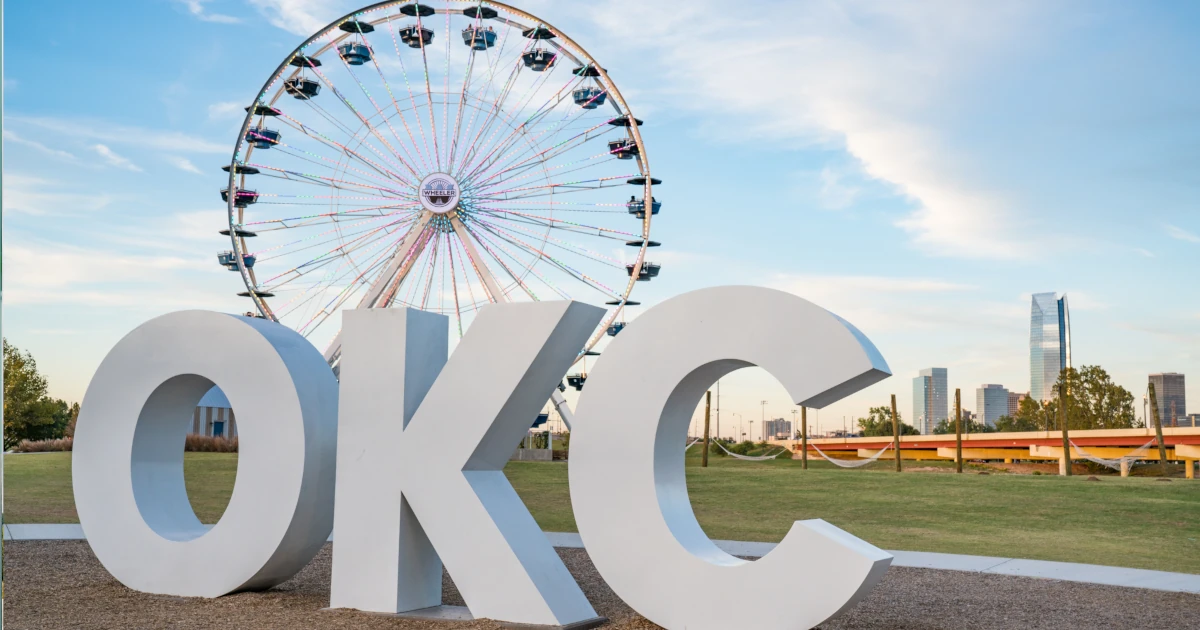 Oklahoma City sign with ferris wheel behind it