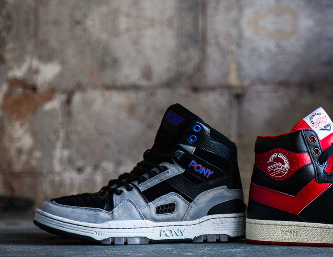 red and blue pony sneakers against brick wall