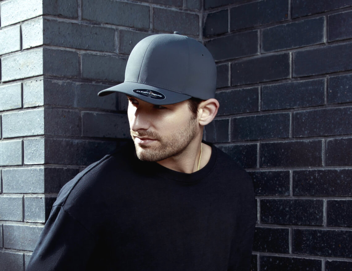 man wearing black flexfit cap
