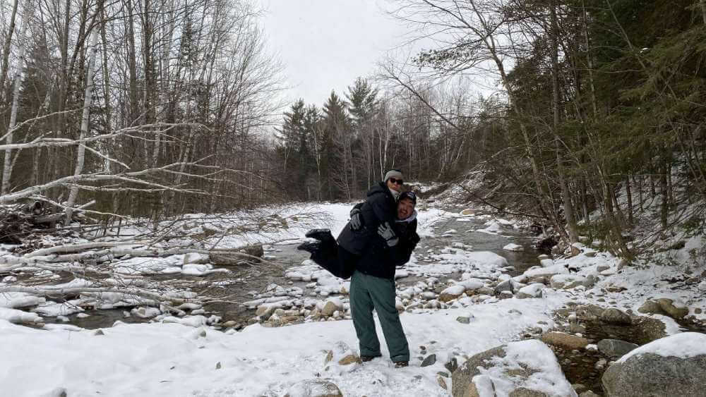 Carlos and partner at winter river landscape