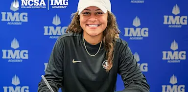 Student-athlete signing a college commitment at IMG Academy, wearing a Florida State cap, with NCSA College Recruiting and IMG Academy logos in the background.