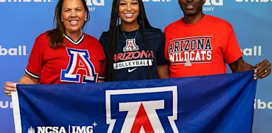 Student-athlete stands between two family members holding an Arizona Wildcats banner during a college commitment celebration, with NCSA College Recruiting and IMG Academy branding in the background.