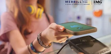 Student using a smartphone to make a contactless payment, with Merrill and IMG Academy logos visible, representing a student guide to managing money and financial literacy.