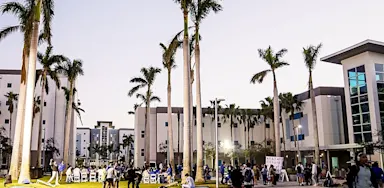 Students and visitors gathered on campus in the courtyard at IMG Academy during the evening.