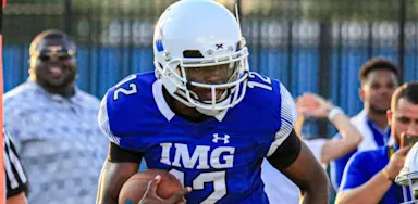 A helmeted football player stands ready on the field.