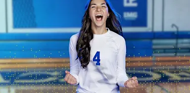 IMG Academy volleyball athlete celebrating on the court with clenched fists, representing confidence, motivation, and mental performance success.