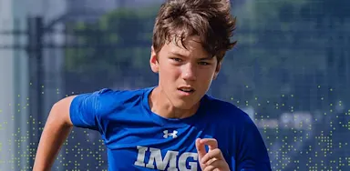 IMG Academy student athlete sprinting during outdoor training, demonstrating speed, focus, and athletic performance.