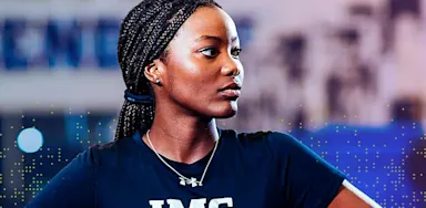 IMG Academy student athlete standing with hands on hips during training, looking focused and determined.