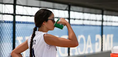 Student-athlete fueling during a practice.