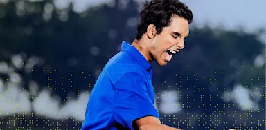 IMG Academy golfer celebrating with a fist pump on the course, expressing confidence, focus, and competitive success.