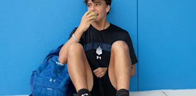 Student-athlete eating an apple