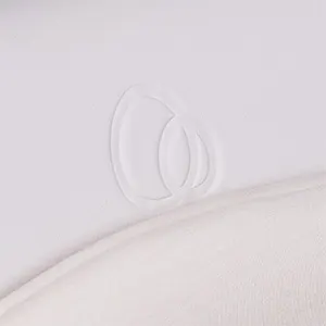 Close-up of the cream vegan leather seat with a tonal embossed Puggle logo and soft jersey liner.