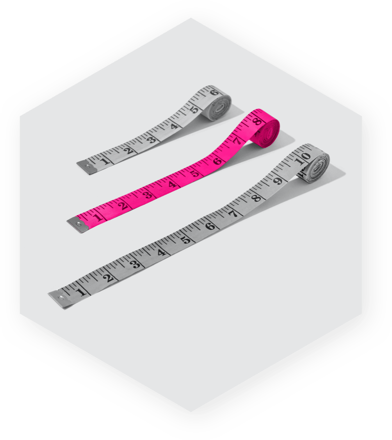 Image of two grey measuring tapes and one pink measuring tape within a hexagon on grey background.