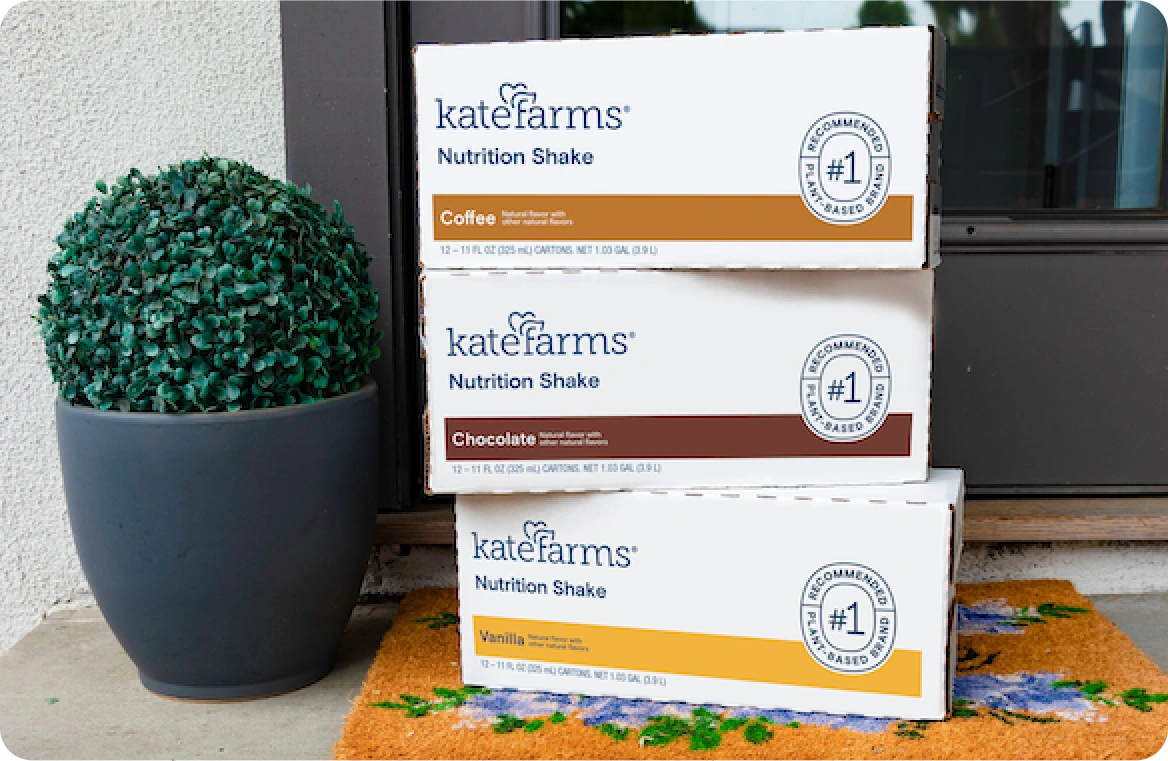 3 boxes of Kate Farms coffee, chocolate, and vanilla nutrition shakes stacked