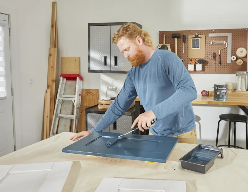 A man applies first coat of paint