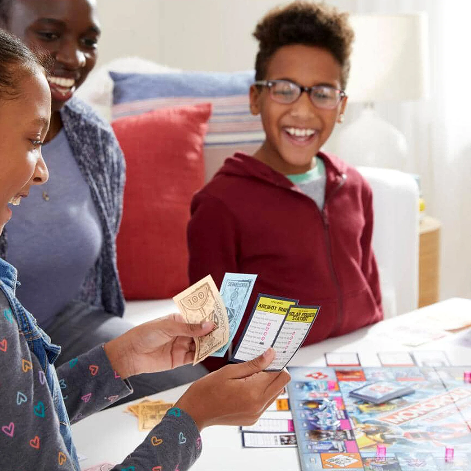 Black family, playing card games at family table