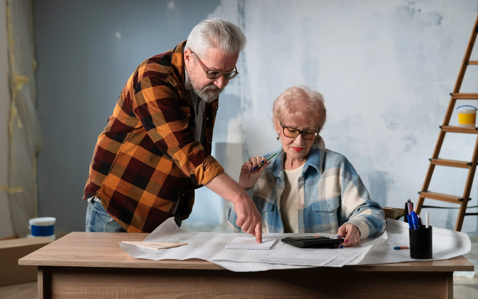 Image of an older couple reviewing renovations plans.