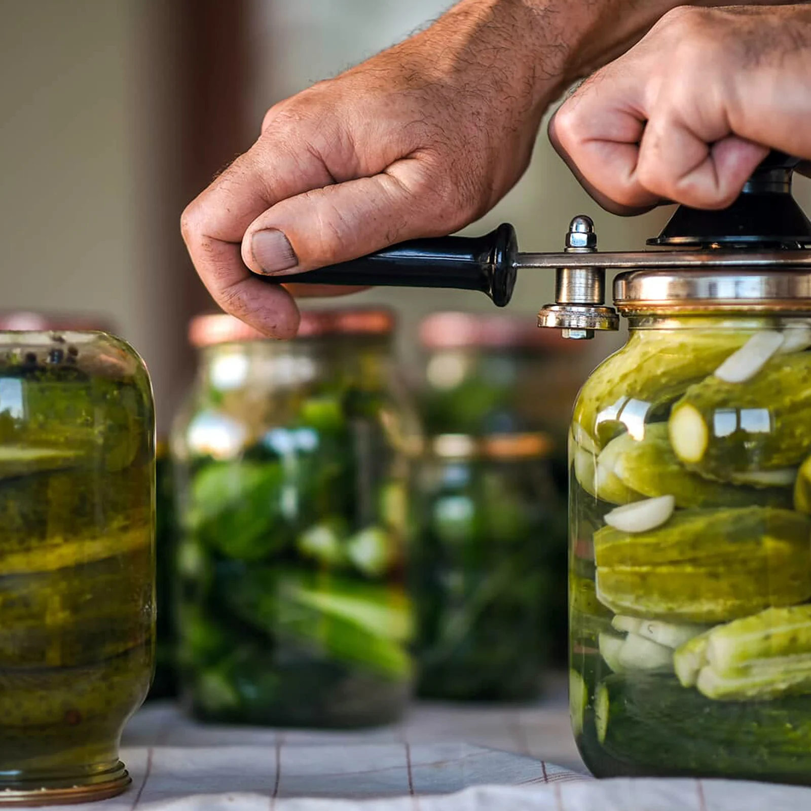 Man opening or tightening canning jars