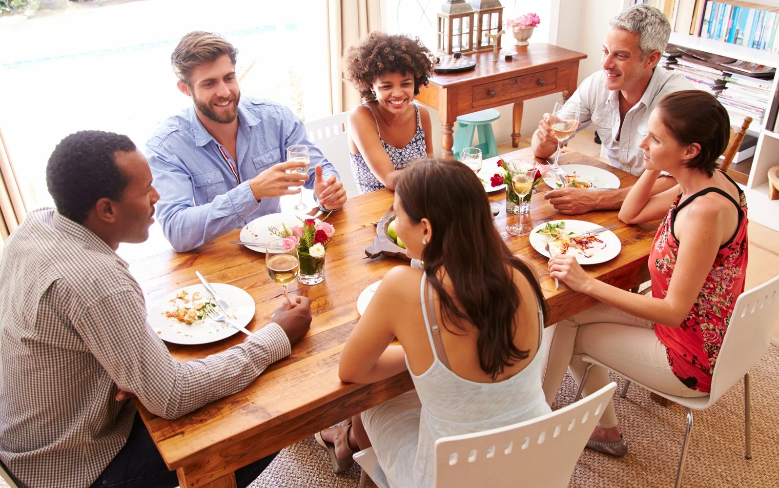 Image of a group of friends a home dinner party.