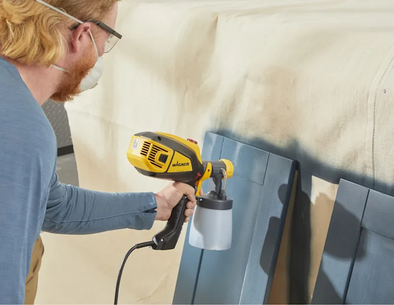 A man adds second coat of paint