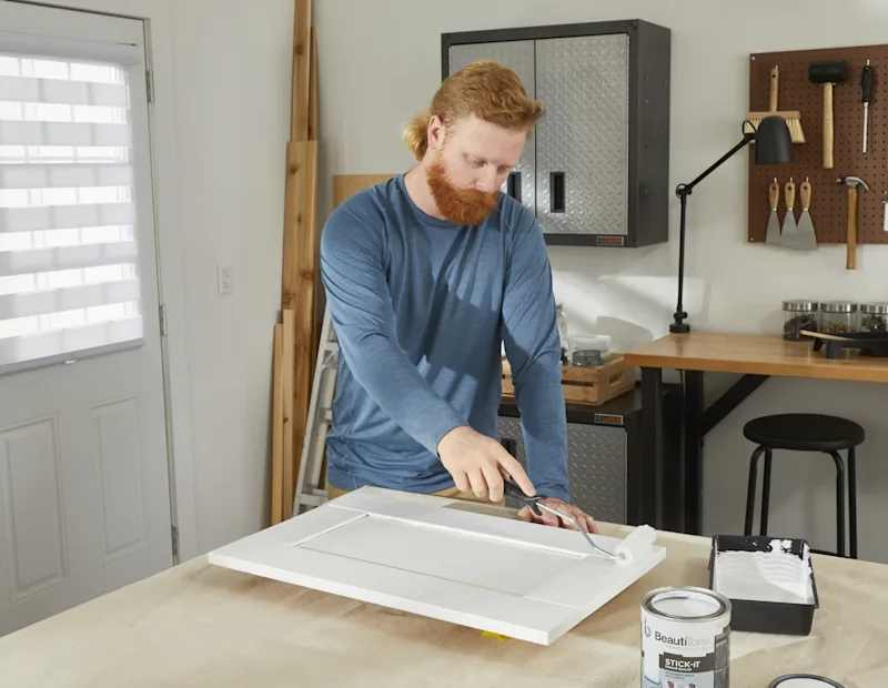 A man adds paint primer