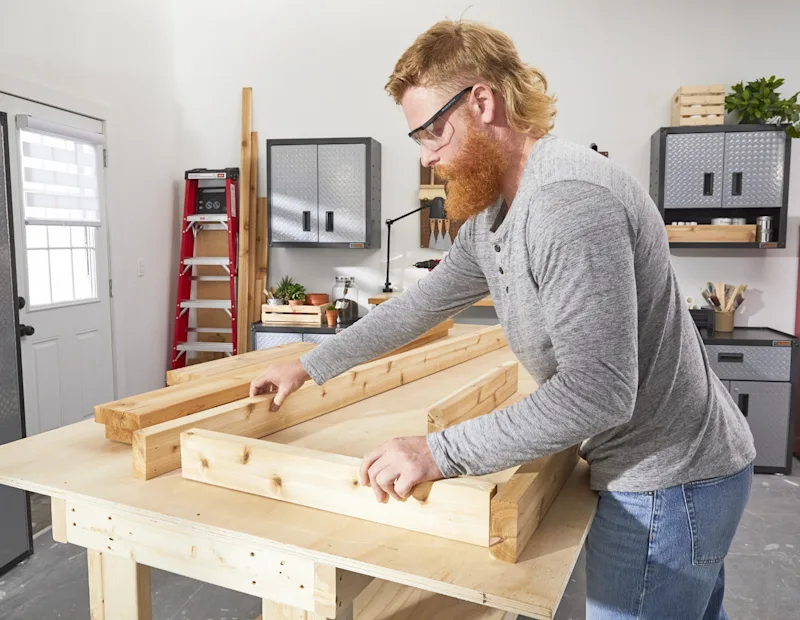 A man putting together the 2 frames.