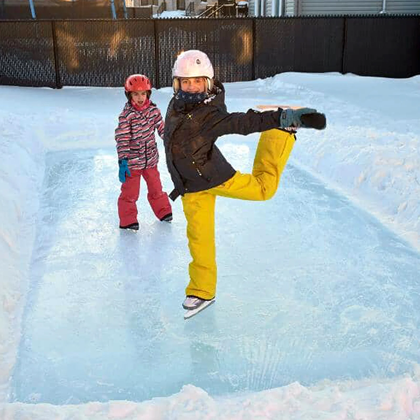 Children skating on a homemade, backyard ice rink