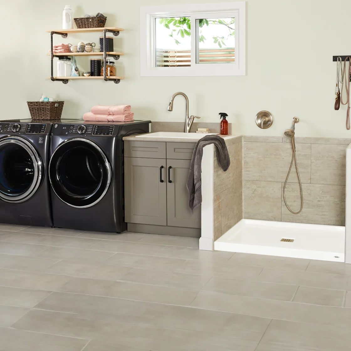 A laundry room with a dog grooming station