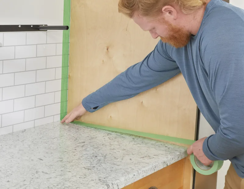 Some adds tape to protect walls