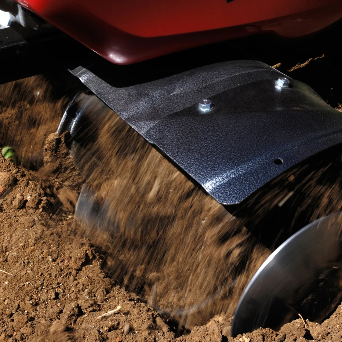 Someone aerates the garden soil.