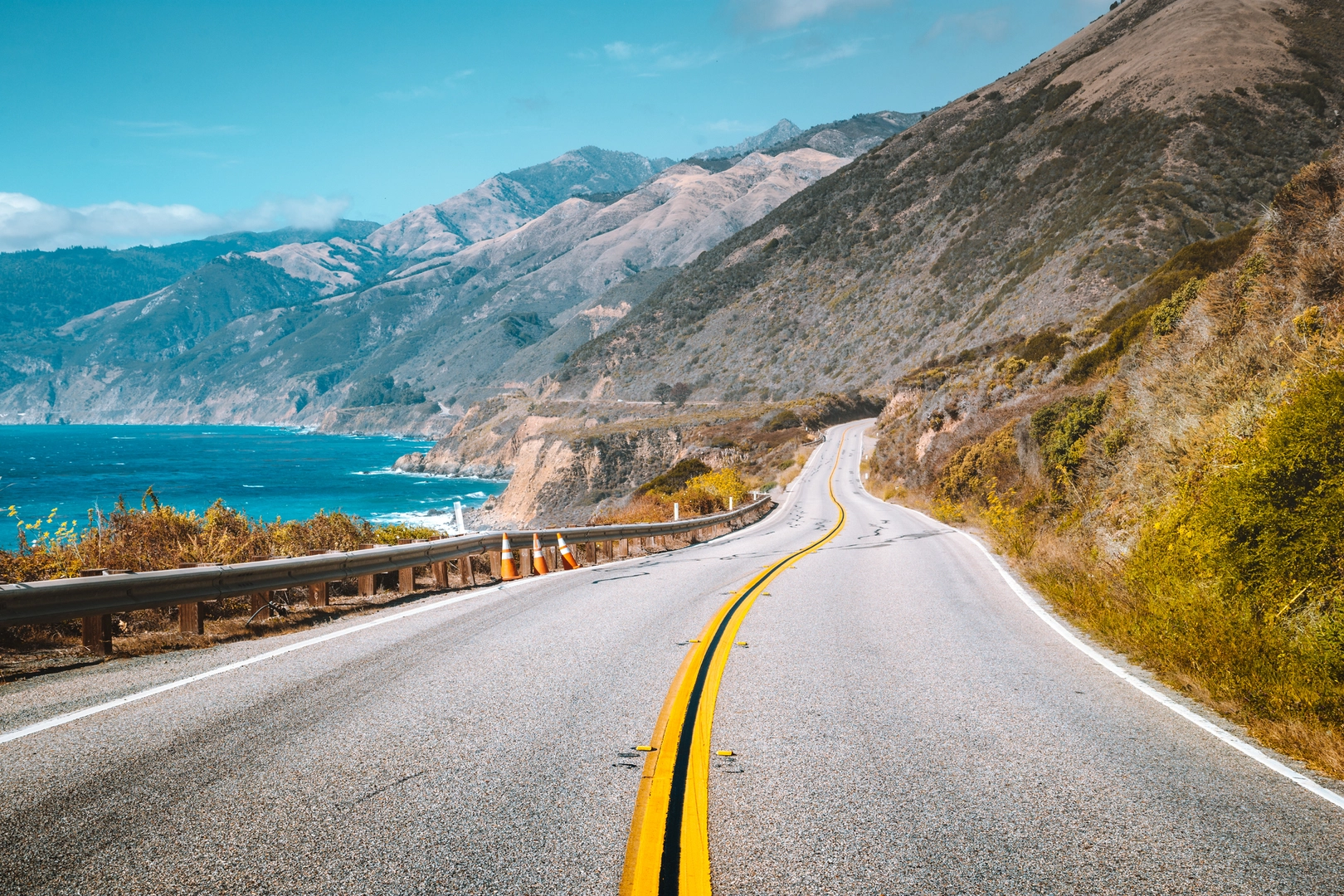 Scenic view of world famous Highway 1 with the rugged coastline of Big Sur in beautiful golden evening light at sunset in summer, California Central Coast, USA