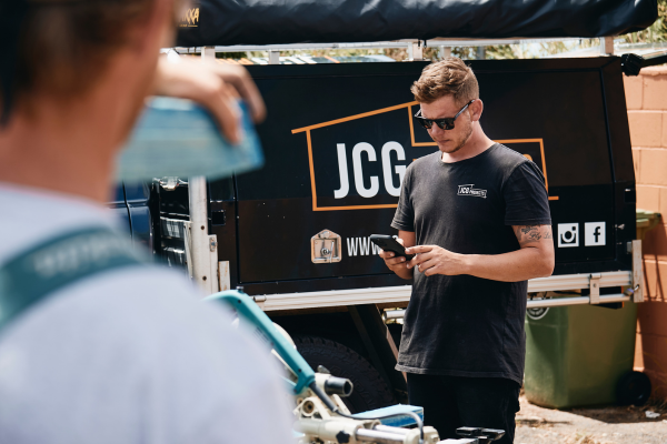 Business owner, Johnno Green, accessing his business information on his phone from a construction site