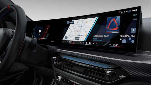 Interior of a modern car showing a digital dashboard with navigation map, media player, and various controls.