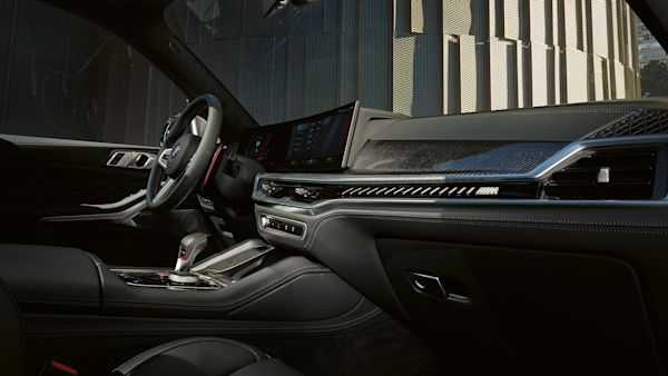 Interior view of a modern car showcasing the dashboard, steering wheel, and center console with a sleek design and advanced technology features.