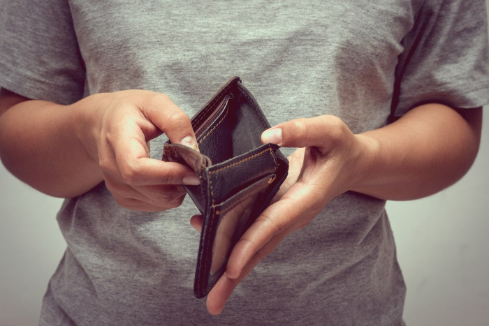 Person holding an empty wallet open