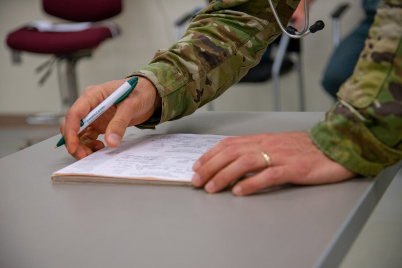 military doctor signing paperwork 