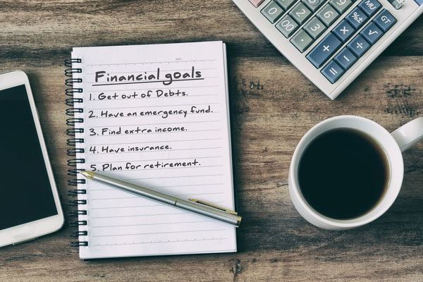 A list of handwritten financial goals. 