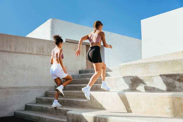 two women running up stairs outdoors