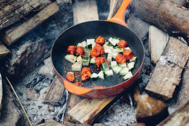 veggies in a cast iron pan on wood fire