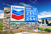 Sun shines on the display stand for a Chevron gas station