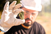 miner holding gold nugget
