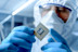 Manufacturing Factory Design Engineer in Sterile Coverall Holds Microchip