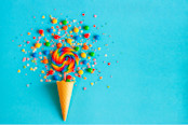 Ice cream waffle cone with colorful lollipop on stick