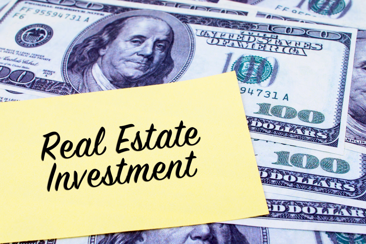 Real Estate Investment written on a yellow paper
