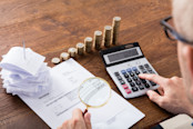 Auditor Hand Checking Invoice