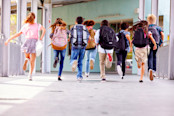 Group of elementary school kids running at school