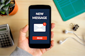 Hand holding smart phone with new message